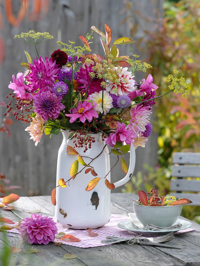 Autumn dahlias bouquet in enamelled jug