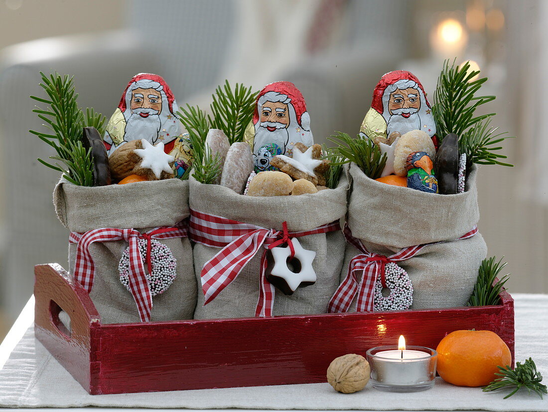 Handstitched linen Santa Claus bag on red wooden tray
