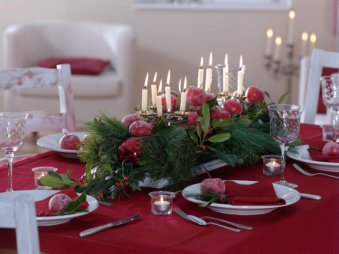 Festive Christmas table decoration with coniferous arrangement