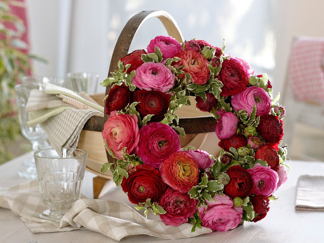 Ranunculus wreath leaning against basket