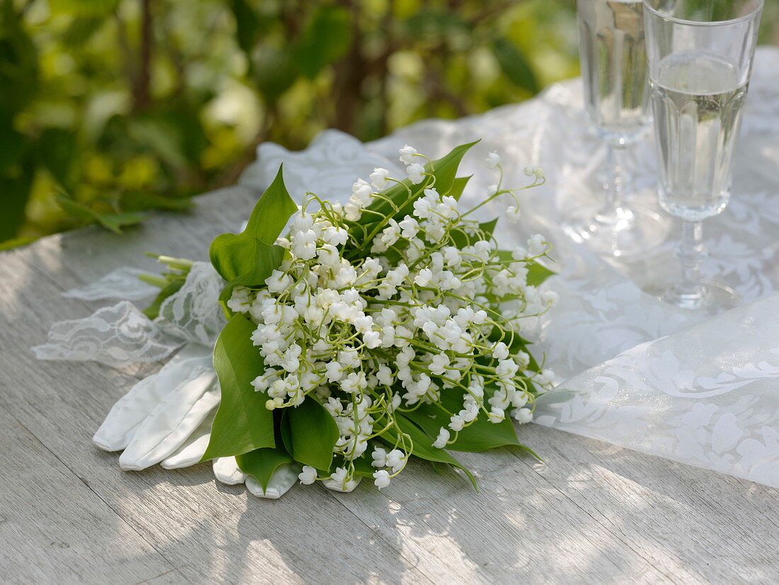 Bridal bouquet of Convallaria majalis, white lace ribbon
