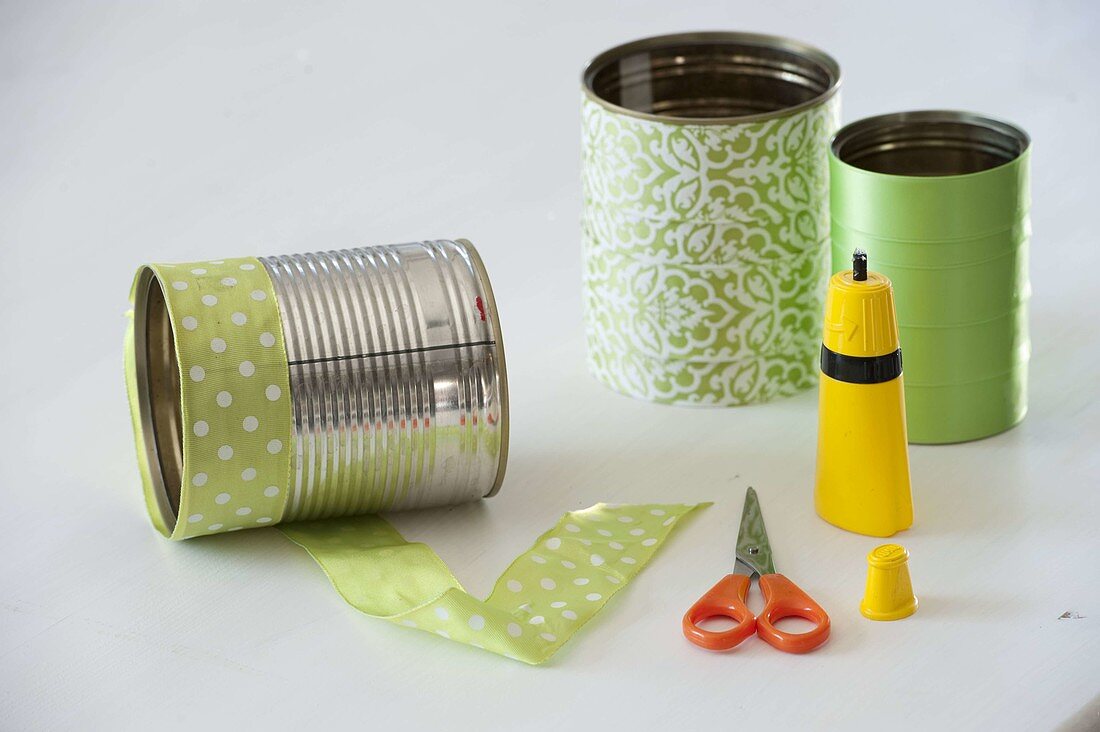 Tin cans spiced up with green ribbon