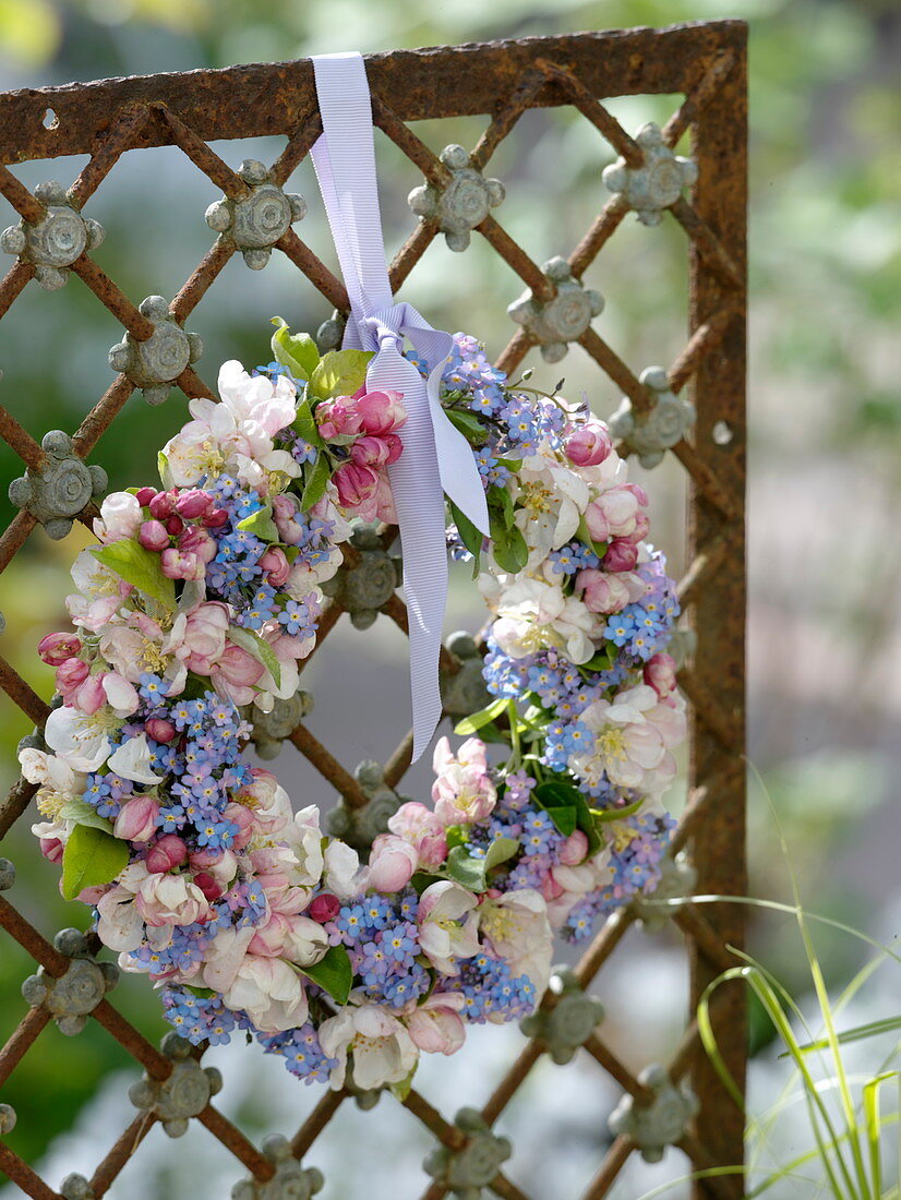 Spring flowers wreath on fence element