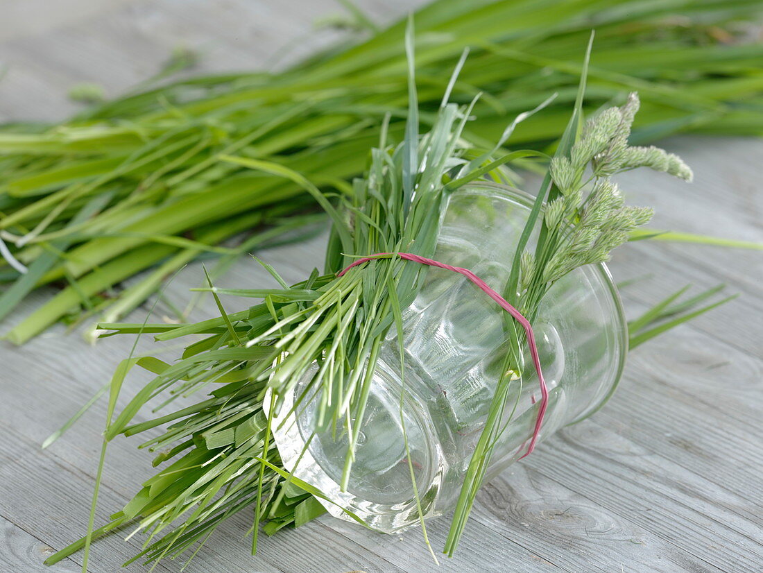 Glass covered with grass as a vase
