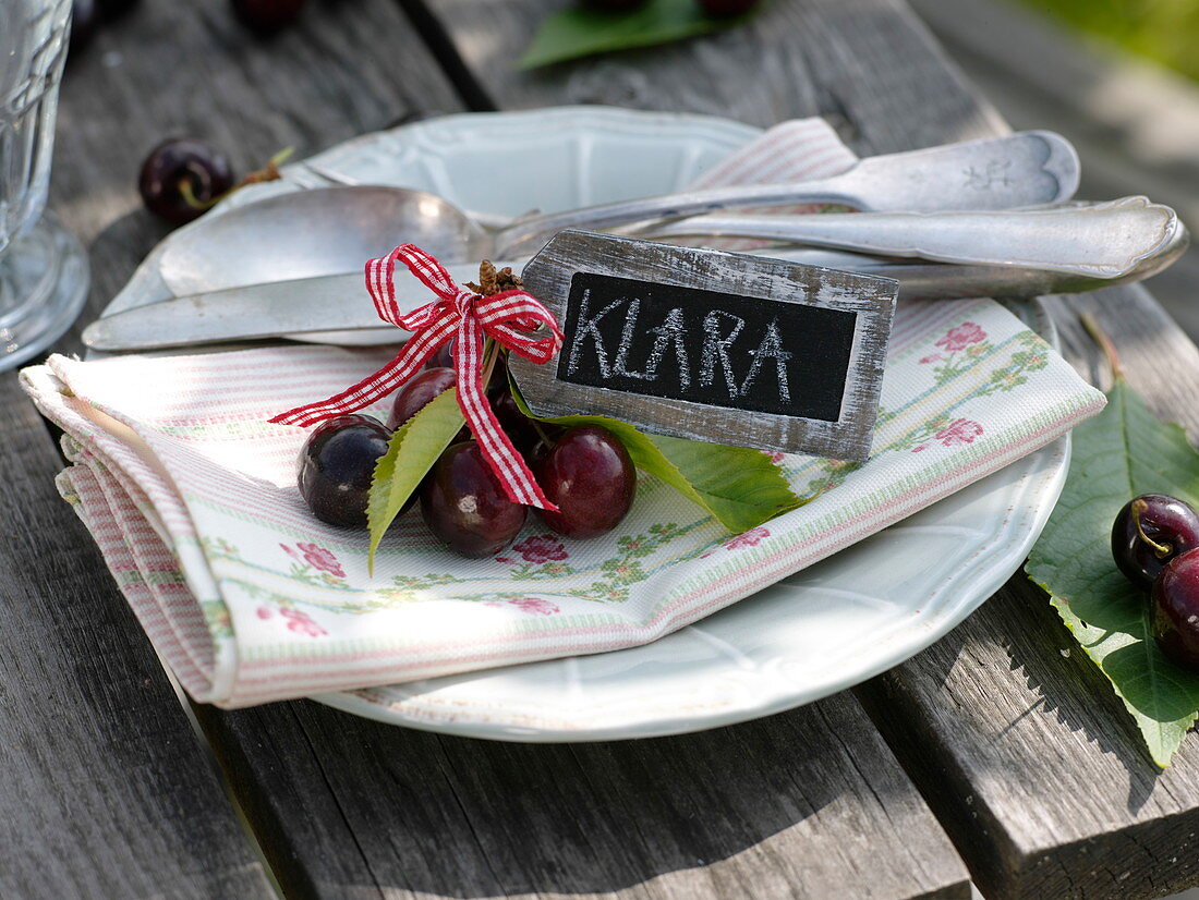Sweet cherries with leaves and small slate
