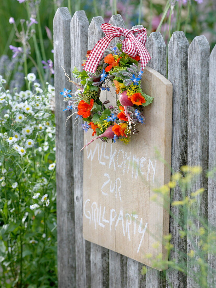 Small wreath of edible flowers, herbs and radishes