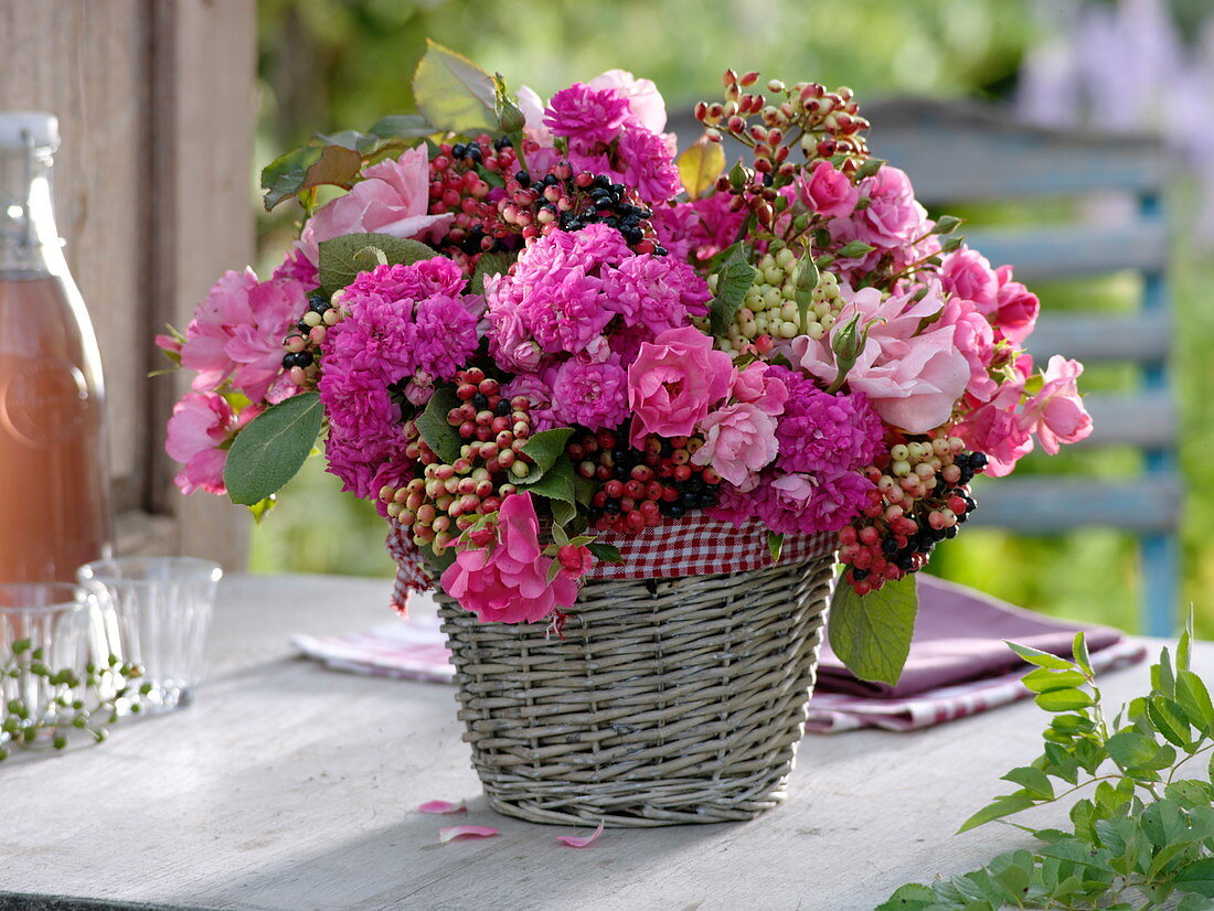 Pink (rose) and Viburnum lantana fruit stalks arrangement