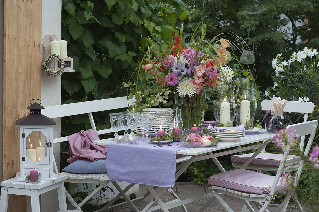 Evening terrace table decoration with lanterns, dahlia and hydrangea