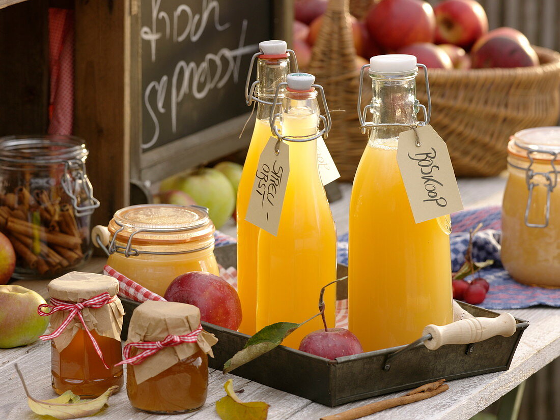 Bottles of freshly squeezed apple juice, jars of jelly and applesauce