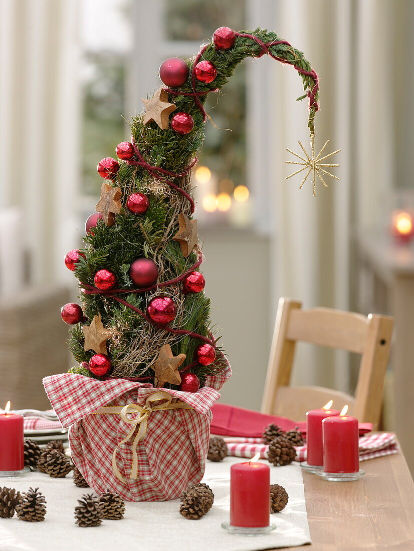 Tree made of coniferous green, decorated with red balls