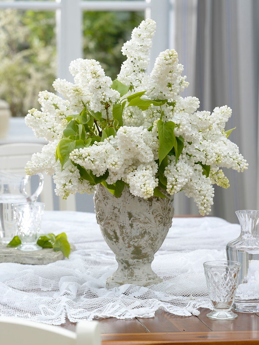 Fragrant syringa (lilac) bouquet in a rustic vase