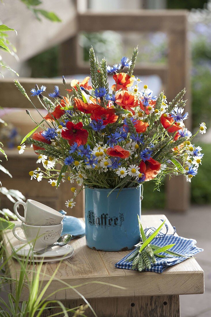 Meadow bouquet in old enameled coffee can