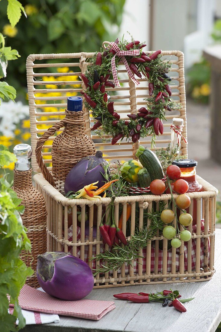 Gift basket with vegetables, herbs and preserves