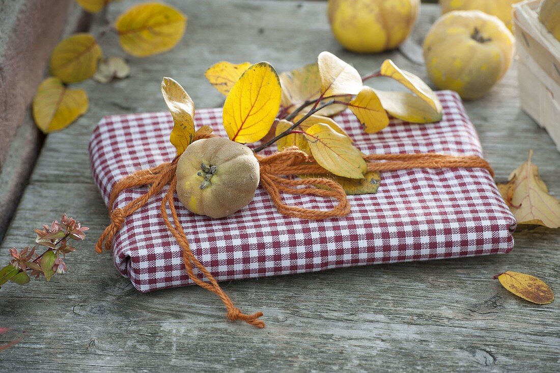 Gift wrapped in a napkin and decorated with quince