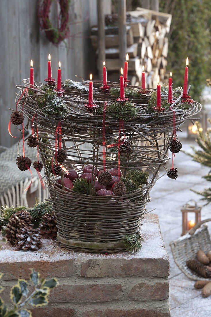 Homemade wicker basket with candles, filled with apples
