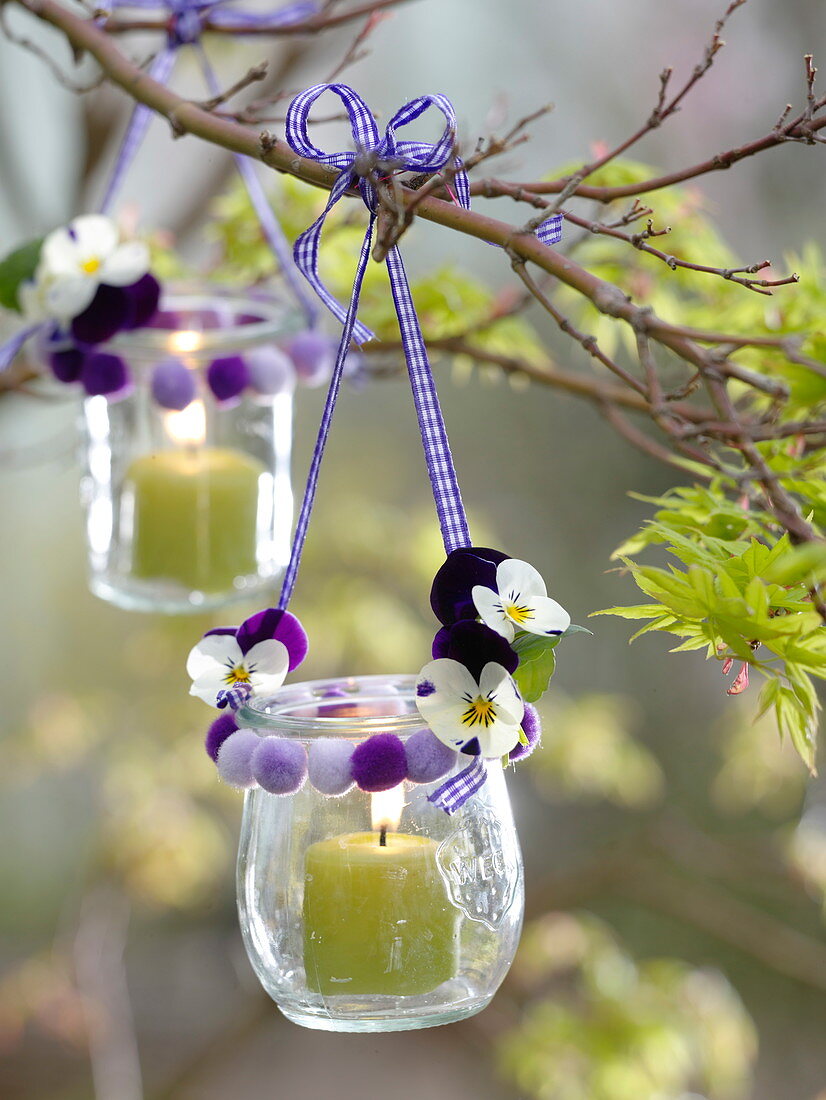 Preserving jars as lanterns with pompoms and Viola cornuta flowers