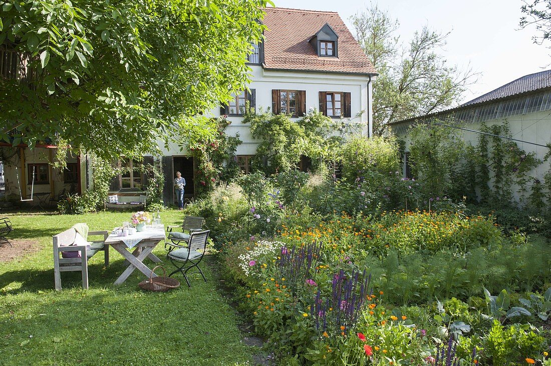 Colourful garden with summer flowers and vegetables