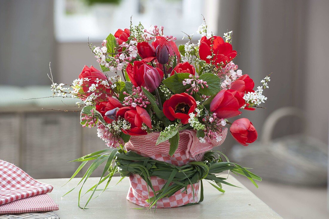 Red-white bouquet with Tulipa (tulip) and Viburnum branches