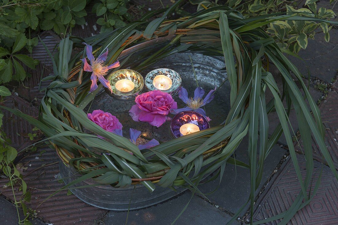 Zinc tub with floating lights and flowers