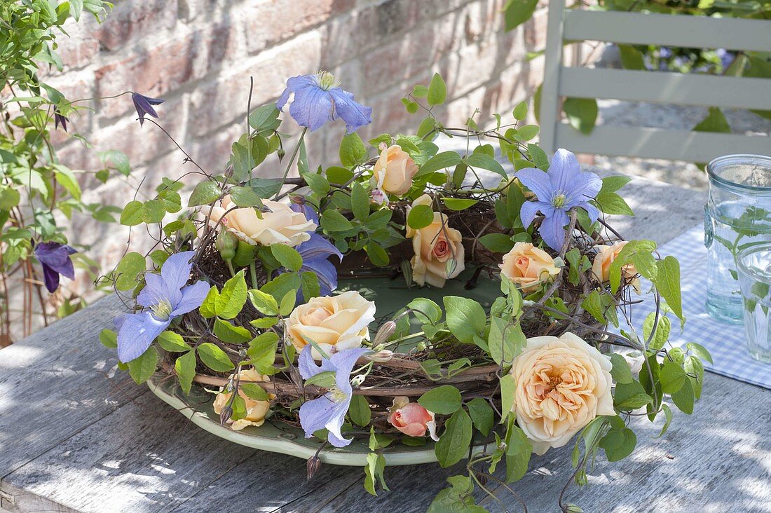 Wreath of Rosa 'Candlelight' (roses), Clematis 'Perle d'Azur' (woodland vine)