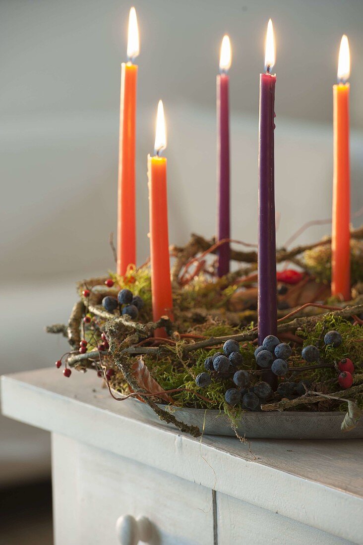 Wreath made of natural materials with candles on zinc-