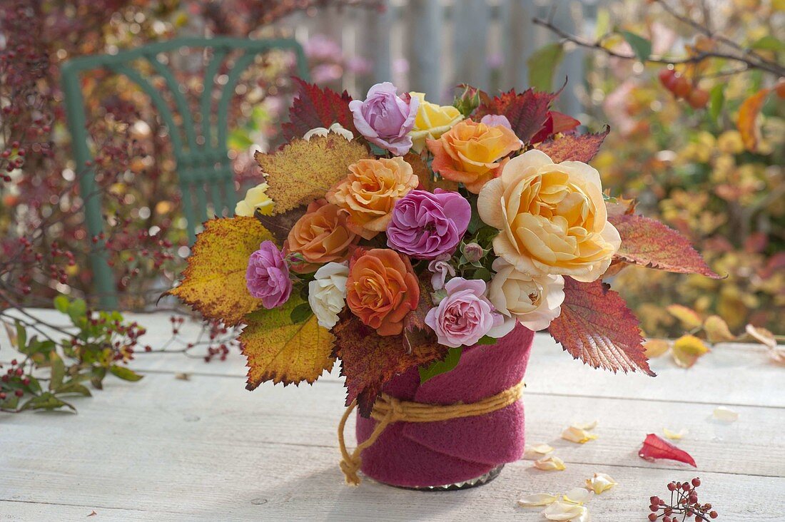 Autumn bouquet of mixed pinks (roses) and leaves