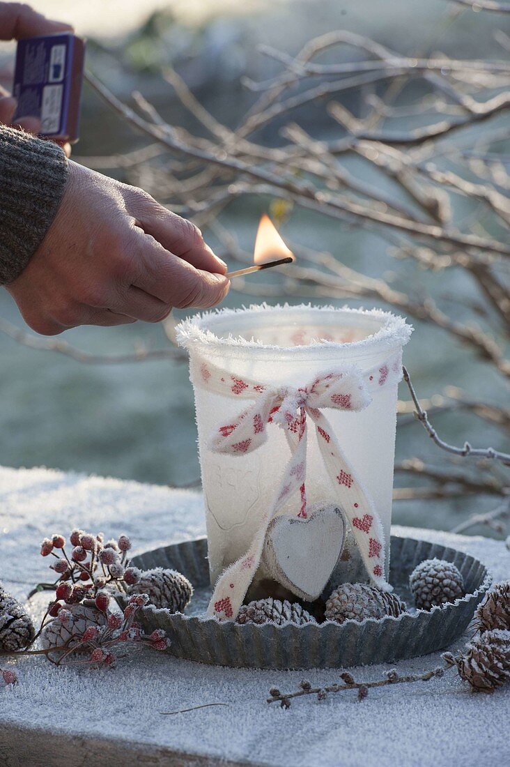 Frozen lantern with ribbon and heart