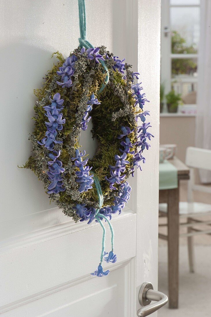 Fragrant spring wreath of moss, lichen covered branches and flowers