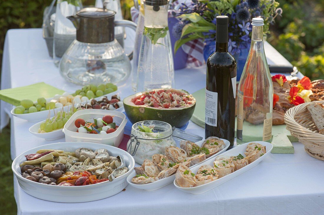 Summer party with friends, table with antipasti, appetizers and drinks