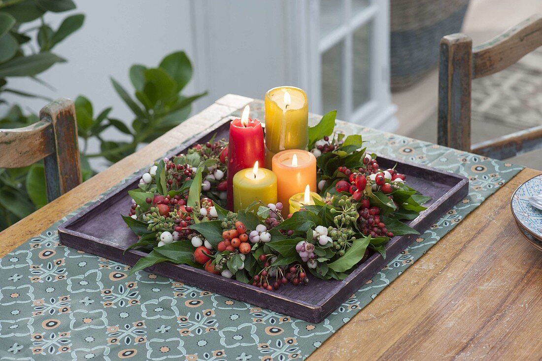 Candles in berry wreath from Symphoricarpos