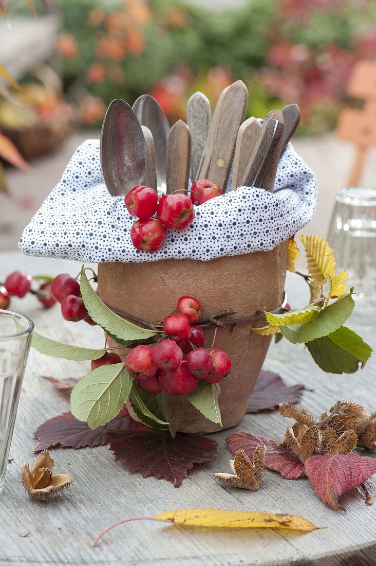 Terracotta pot naturally decorated as a cutlery holder