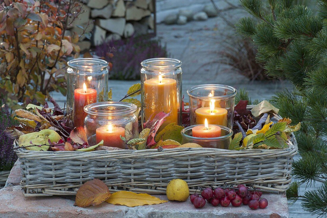 Evening mood on the autumn terrace lanterns in wicker tray