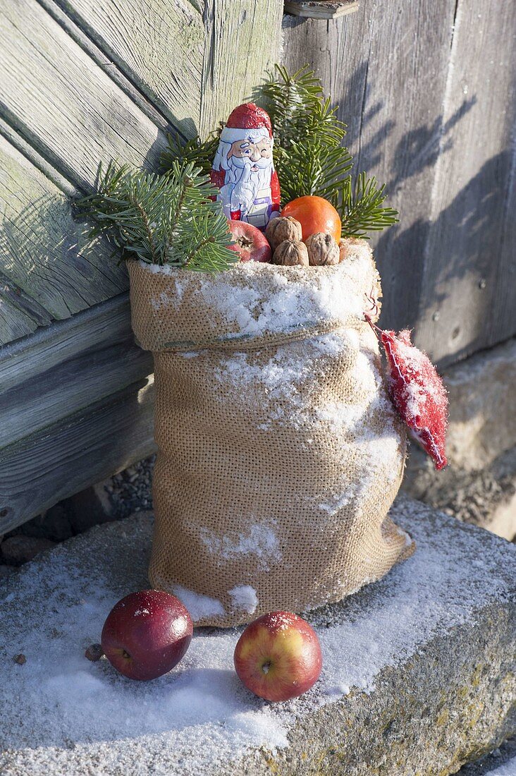 Santa's bag with apples, nuts and tangerine