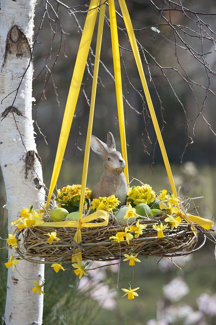 Hanging Easter basket with Salix wreath filled with Easter eggs