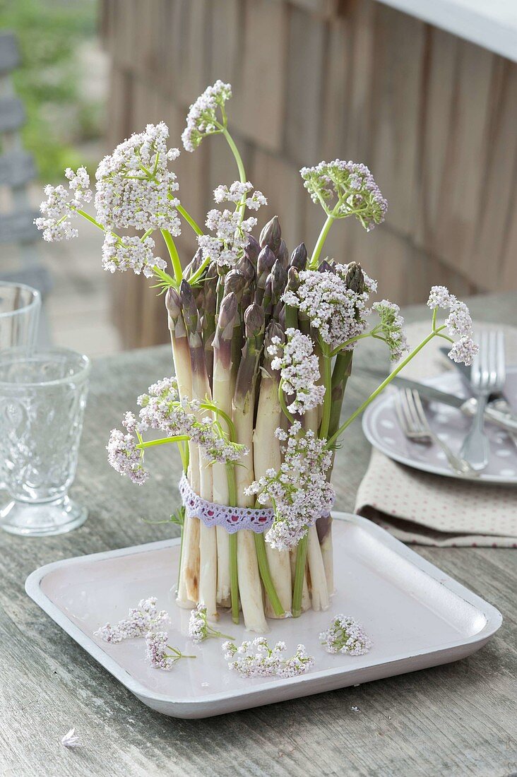 Bouquet of asparagus flowers with valerian flowers
