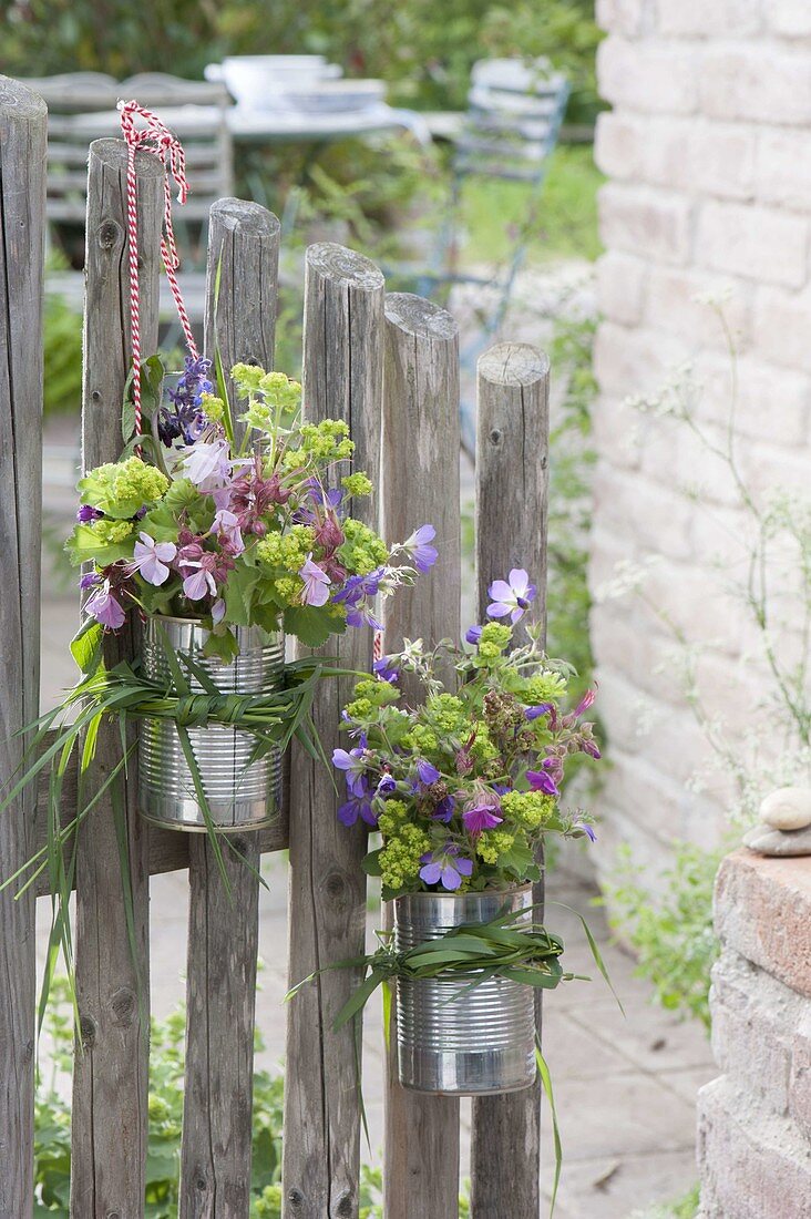 Small bouquets hung in clean tin cans on the garden gate