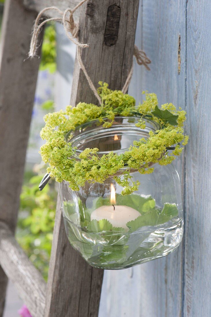 Preserving jar used as a lantern with a flowers profusion
