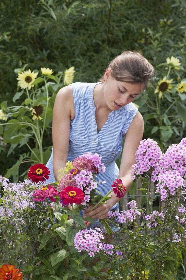 Woman picks flowers for bouquet