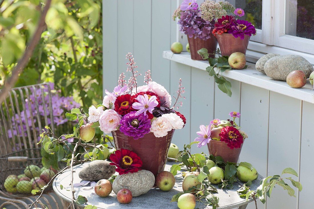 Patio table with apples and small Zinnia bouquets