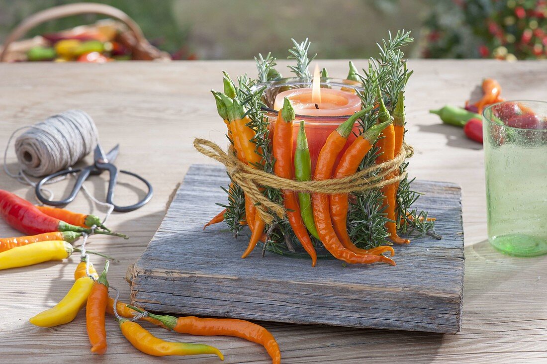 Glass as a lantern with hot peppers and rosemary