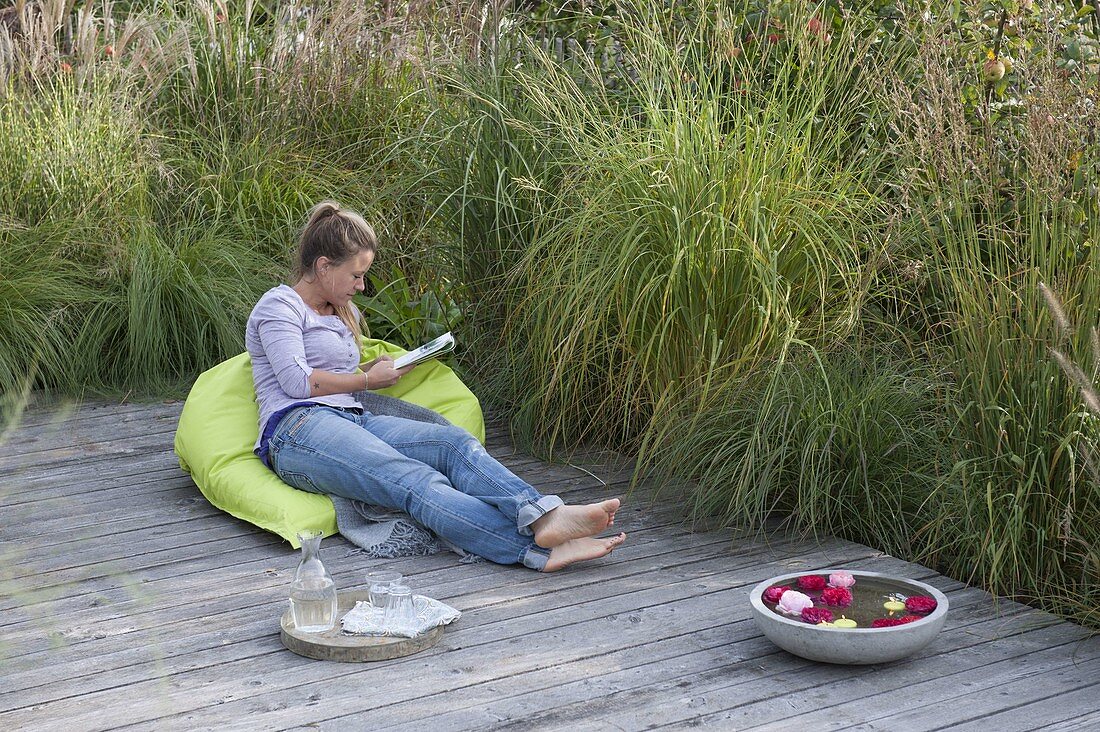 Wooden terrace with grassy bed as a screen