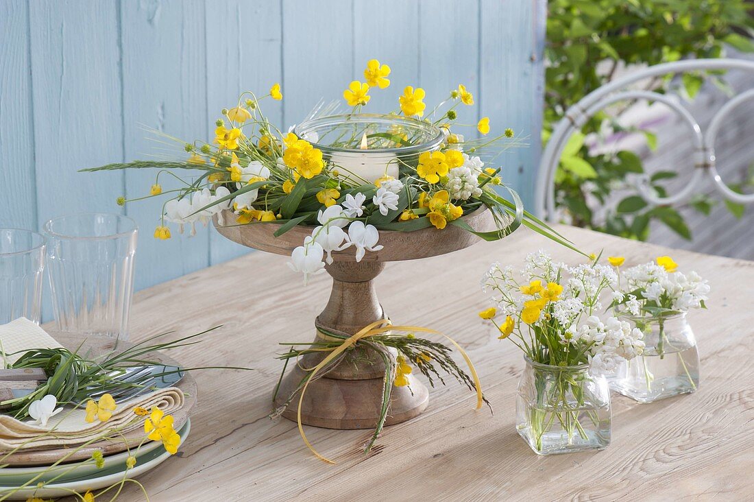 Yellow-white wreath and lantern on wooden bowl with foot