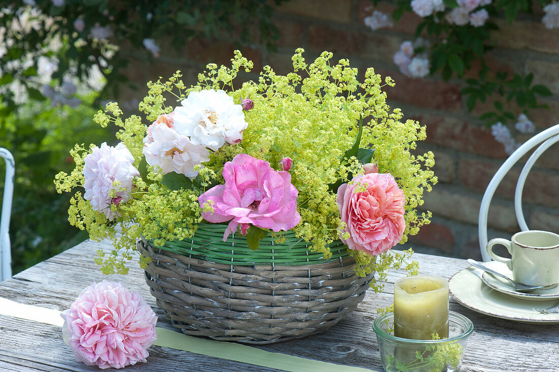 Table decoration with lady's mantle arrangement in the basket