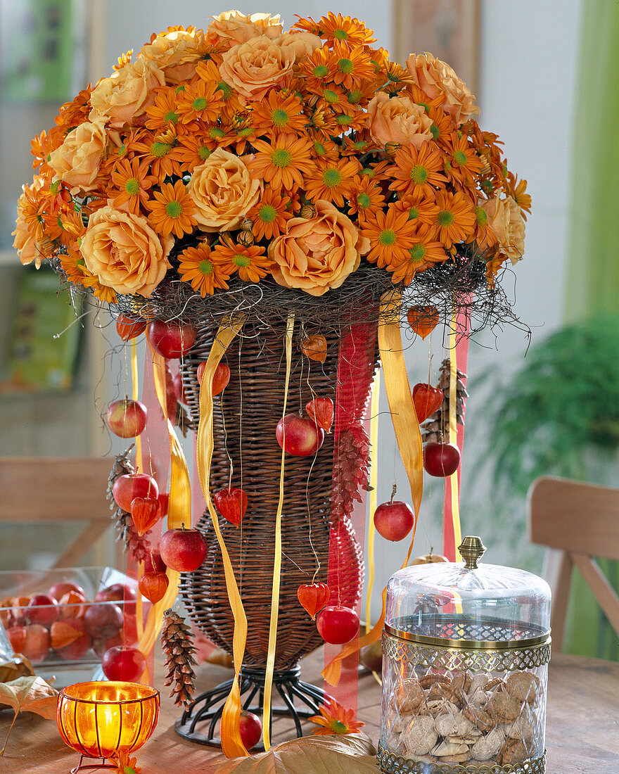 Basket amphora with bouquet of roses and autumn chrysanthemums