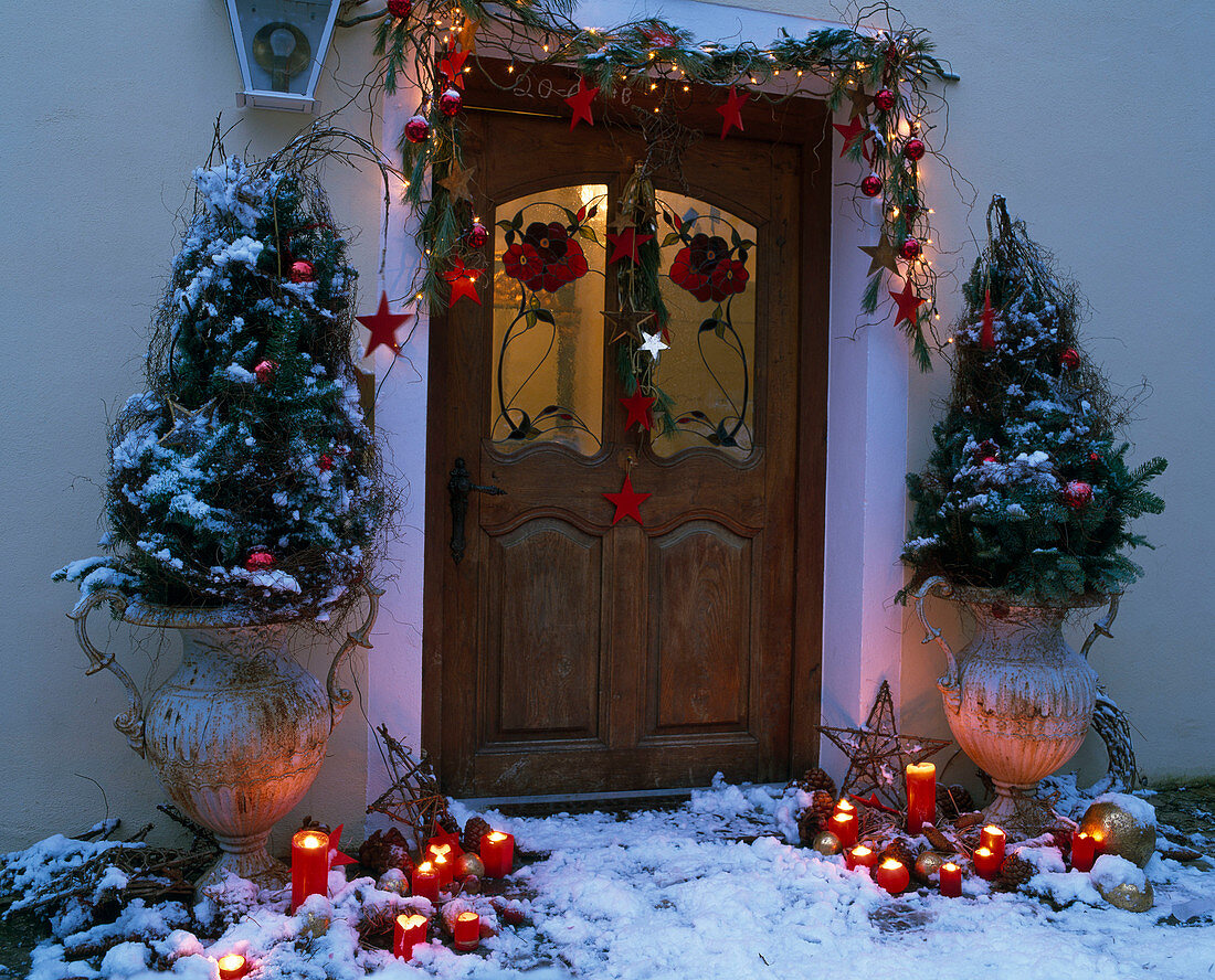 House entrance Christmassy decorated with amphorae, branches