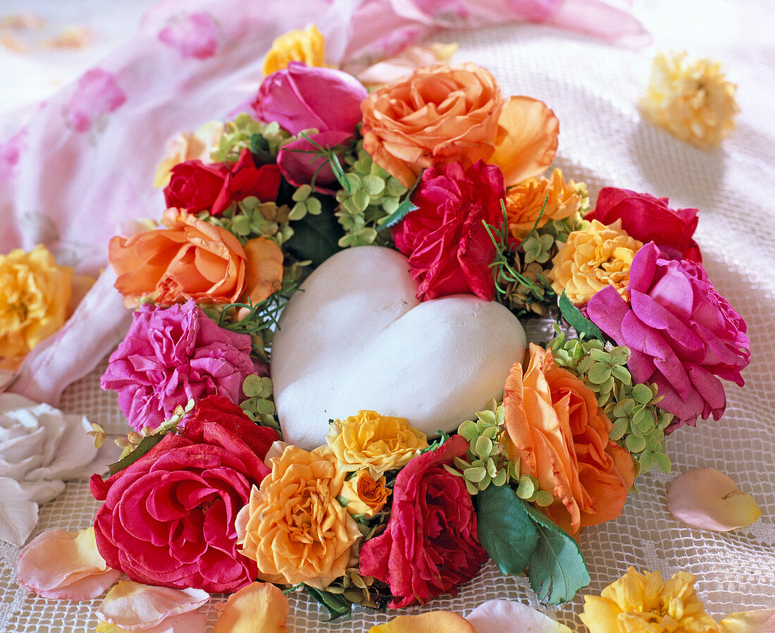 Heart-shaped wreath with various rose petals and hydrangea