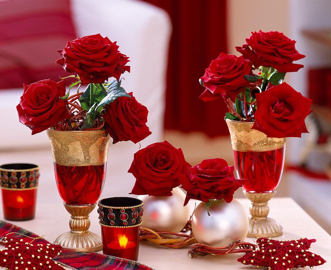 Glass goblets decorated with rose petals for Christmas