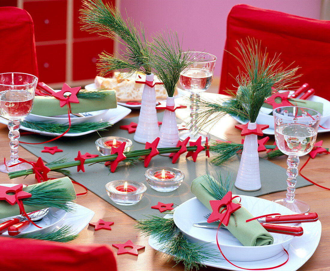 Table decoration with Pinus strobus (silk pine) and red wooden stars