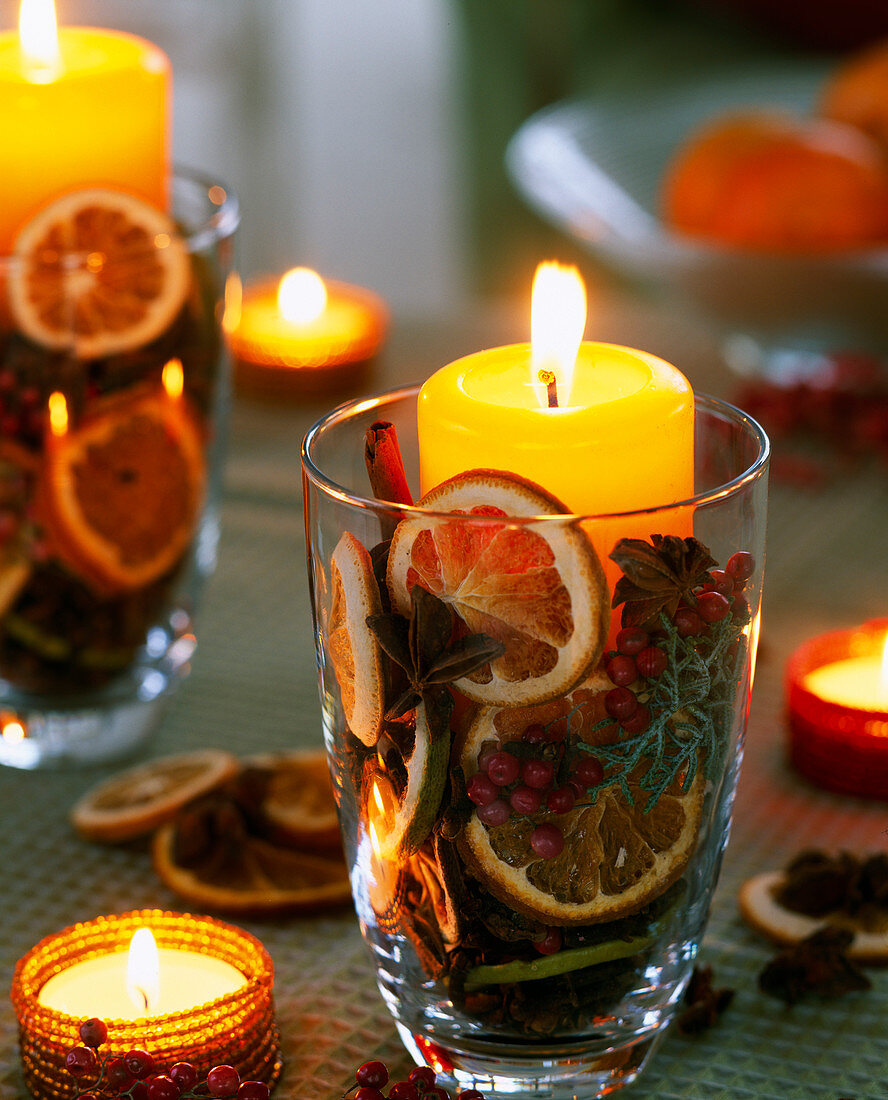 Glass with dried orange slices and candle