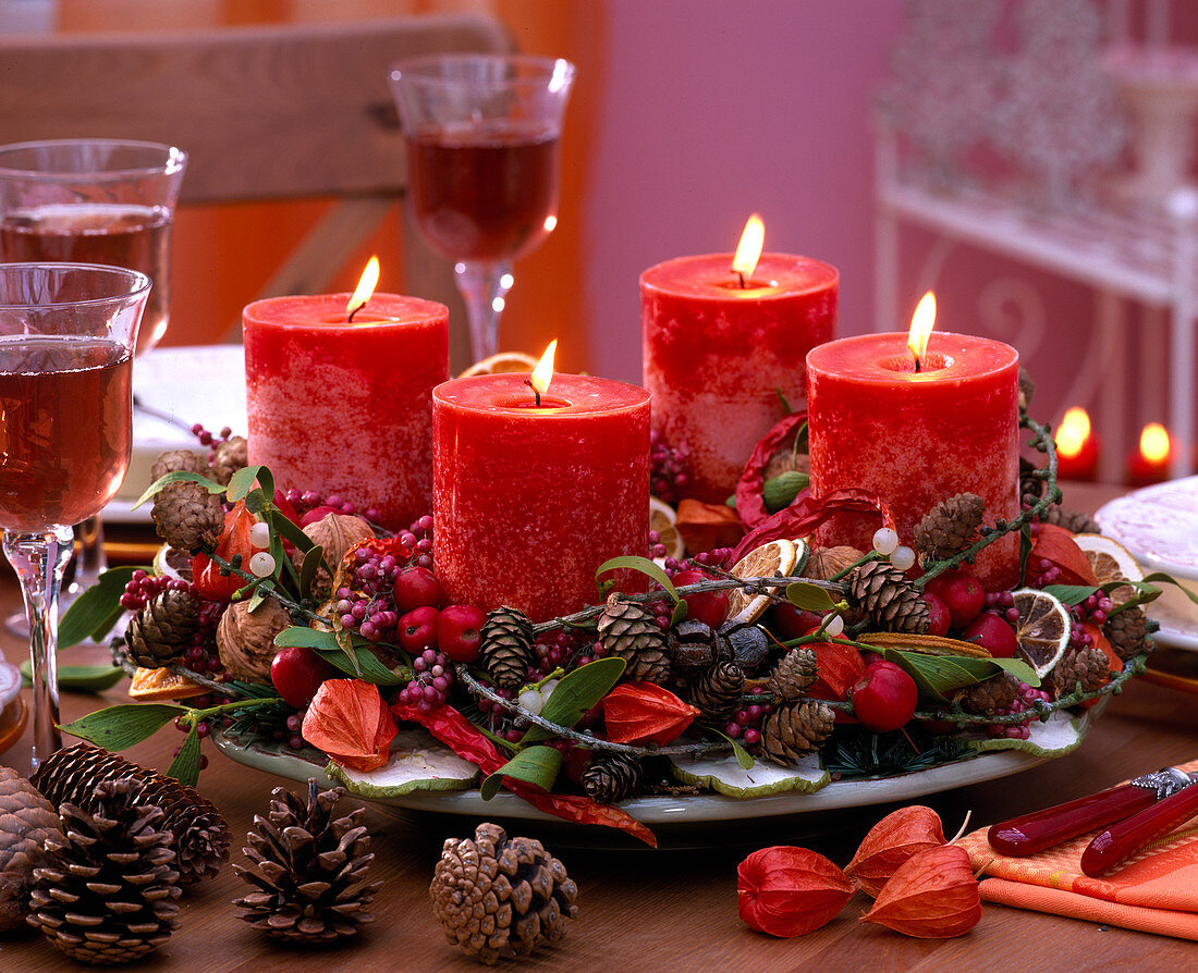 Advent wreath with cones, branches and red candles